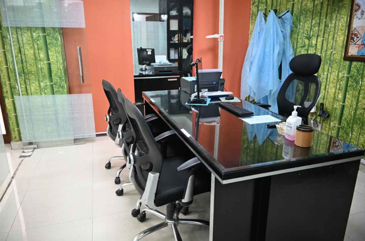 Patient consultation area with digital displays at Muskaan Dentals